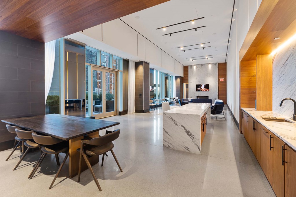 the kitchen and dining area of a large house with a marble table and chairs at The Paxton, Brooklyn, NY